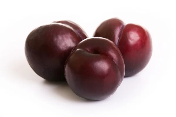Three juicy red plums — Stock Photo, Image