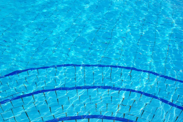 Blauer Hintergrund mit Sonne, die sich im Wasser des Schwimmbades spiegelt — Stockfoto