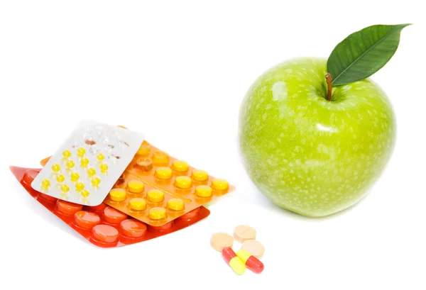 Stock image Green apple and pills