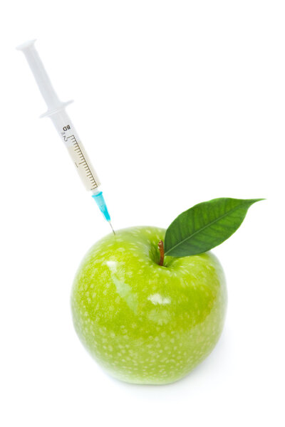 Green apple, pills and syringe