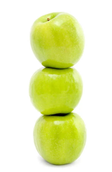 Três maçãs verdes em um branco — Fotografia de Stock