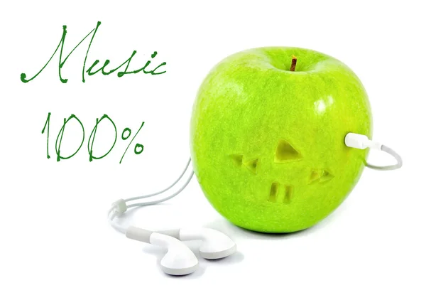 Green apple in which headphones — Stock Photo, Image