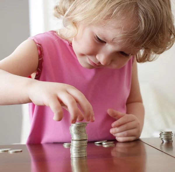 stock image Girl putting coins