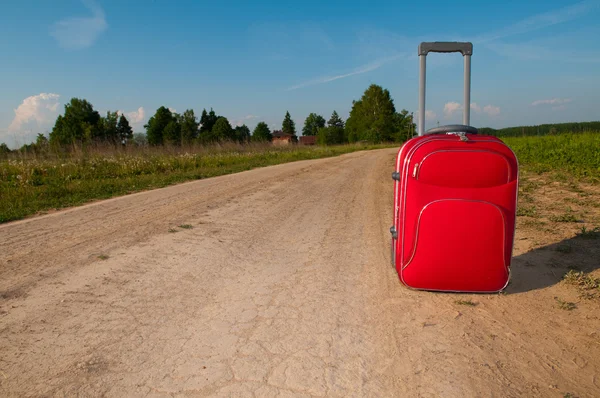 Suitcase on road — Stock Photo, Image