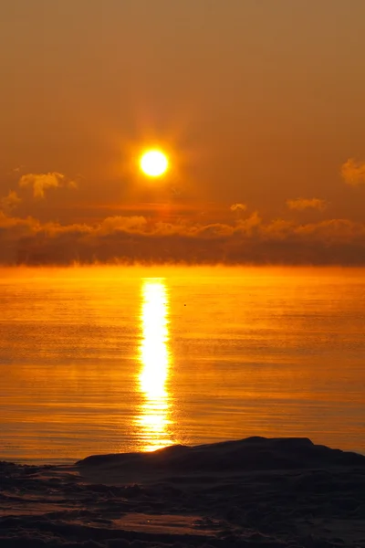 Sunset over icy sea with clouds — Stock Photo, Image