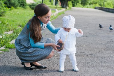 My mother sat next to her daughter on a sidewalk clipart