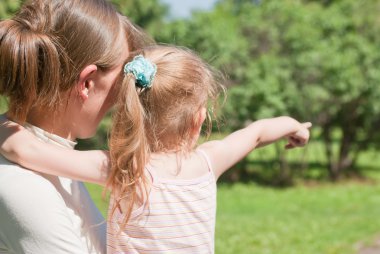 Girl shows her mother a finger to the side clipart