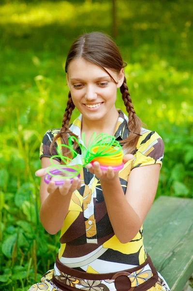 Girl is played with plastic toy — Stock Photo, Image