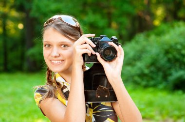 Young girl with camera clipart