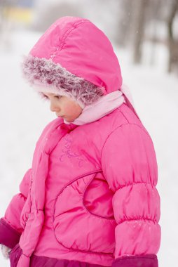 Sad preschool child in pink coat clipart