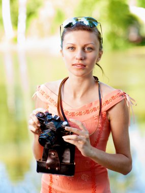 Young girl with camera clipart