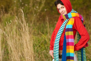 Girl in hood with multi-colored scarfs clipart