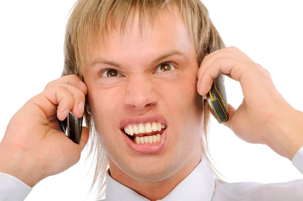 Empresario enojado grita en dos teléfonos —  Fotos de Stock
