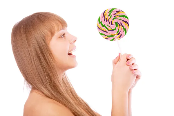 Young girl licks lollipop — Stock Photo, Image