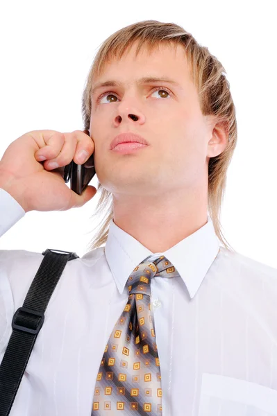 Sad businessman talks on cellular telephone — Stock Photo, Image
