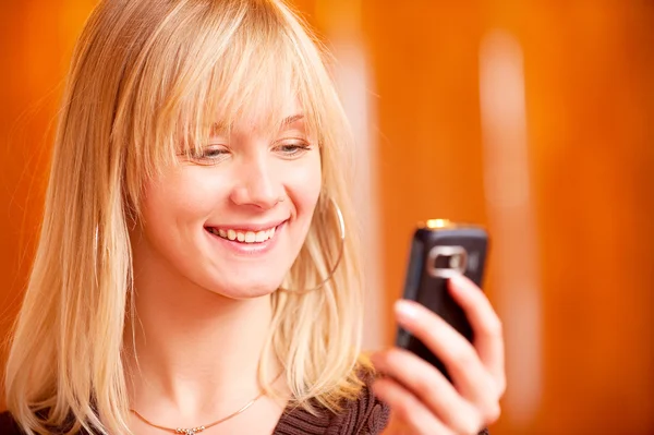 Charming girl reads sms — Stock Photo, Image