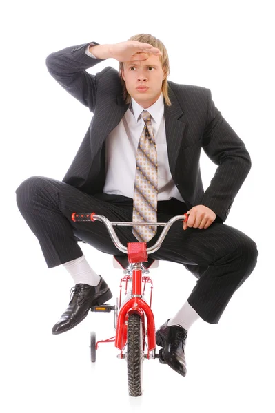 Businessman goes on children's bicycle — Stock Photo, Image