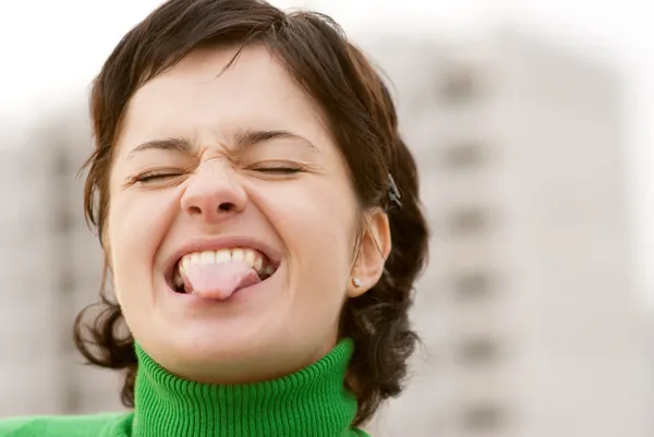 Black hair girl showing tongue — Stock Photo, Image