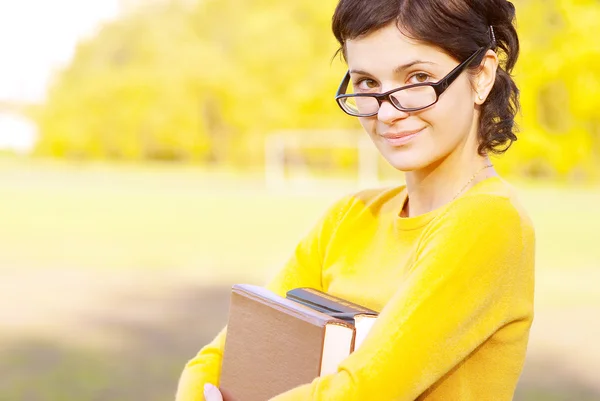 Young student holding books — Stock Photo, Image