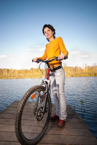 Beautiful girl riding bicycle — Stock Photo, Image