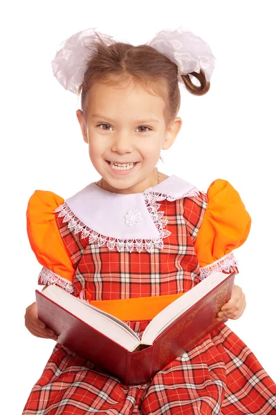 Girl with bows reads book — Stock Photo, Image