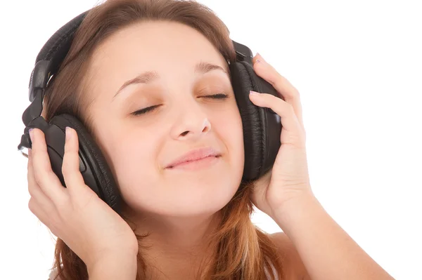 Krásy dívka poslouchat hudbu ve sluchátkách — Stock fotografie