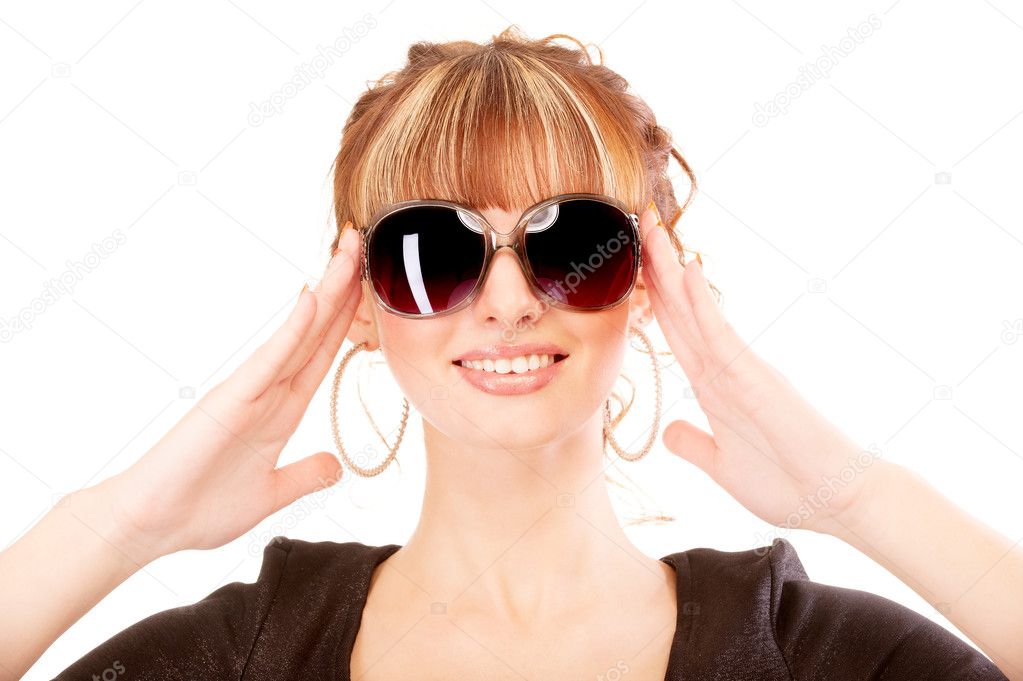 Girl laughs, holding sun glasses
