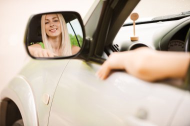 Driver is reflected in mirror clipart