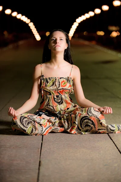 Beautiful girl in lotus pose — Stock Photo, Image