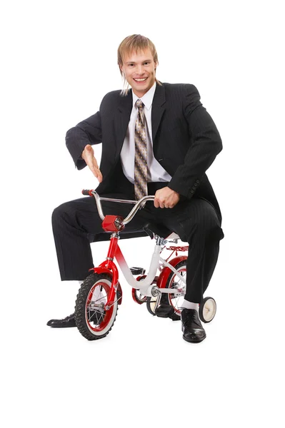 Empresário na bicicleta da criança — Fotografia de Stock