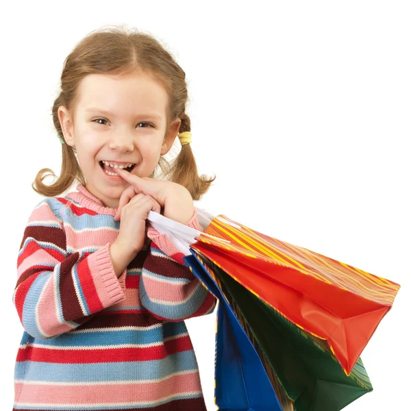 Маленькая девочка с разноцветными пакетами — стоковое фото