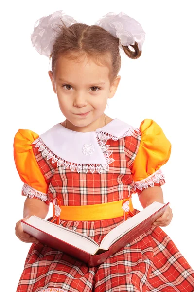 Girl with bows reads book — Stock Photo, Image