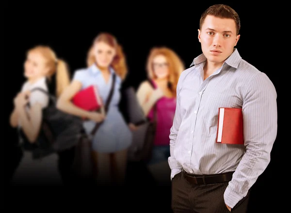 Portrait of young man-student against three girls — Stock Photo, Image