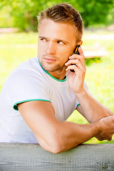 Young man speaks on phone — Stock Photo, Image