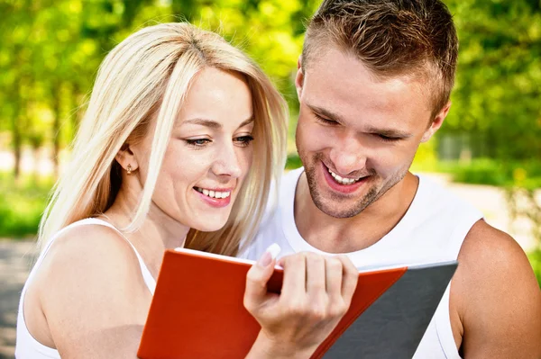 Two students with book — Stock Photo, Image