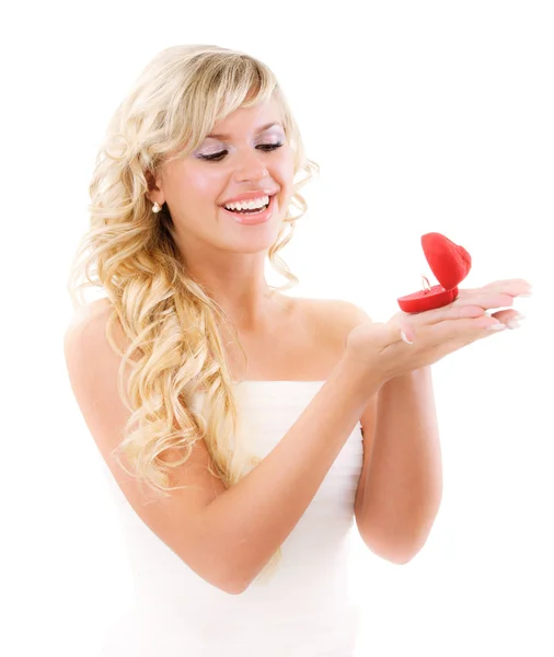 Girl with surprise looks at box with wedding ring — Stock Photo, Image