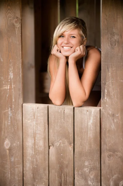 Girl smiles from shed — Stock Photo, Image