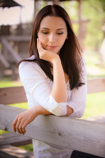 Smiling young woman look down — Stock Photo, Image