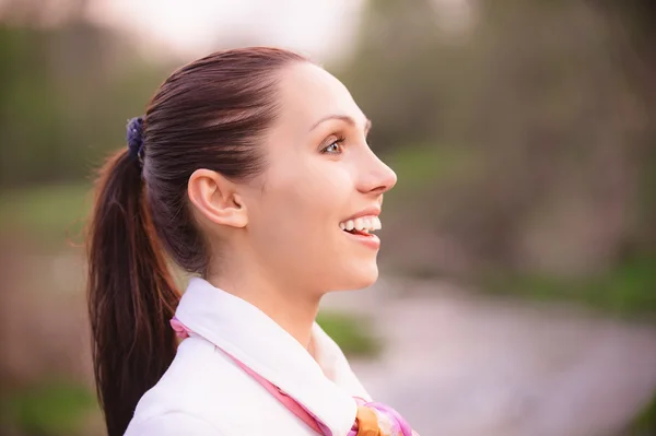 Portrait of smiling girl in profile — Stock Photo, Image
