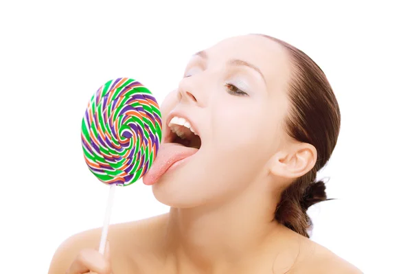 Charming young woman licks lolipop — Stock Photo, Image