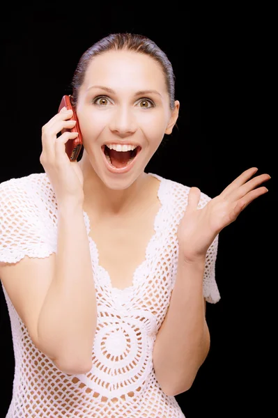 Enthusiastic young woman talks by mobile phone — Stock Photo, Image