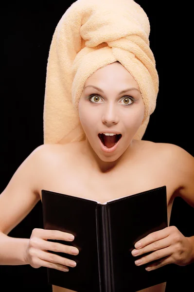 Amazed young woman is covered with book — Stock Photo, Image