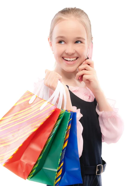 Young girl with purchases speaks by phone — Stock Photo, Image