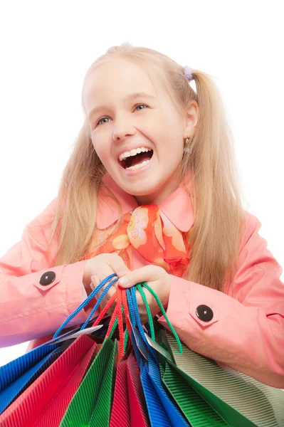 Young girl holds purchases and joyfully laughs — Stock Photo, Image