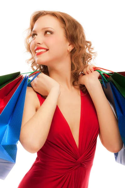 Menina alegre em vestido vermelho com compras — Fotografia de Stock