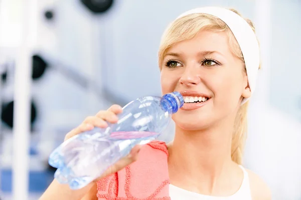 Sportswoman drinks water Stock Image