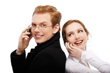 Red-haired couple with cellphones clipart