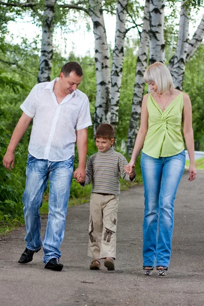 stock image Happy family walking in the park