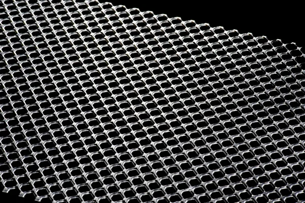 Punched metal on black background — Stock Photo, Image