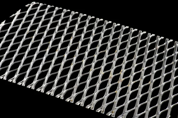 Punched metal on black — Stock Photo, Image
